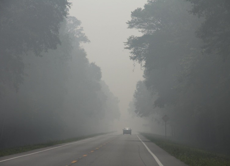 Photo of smoke reducing visibility on a roadway.